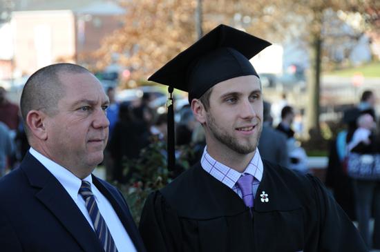 Tyler Hardy and his dad, Jim Hardy, CU assistant football coach, talk after graduation.  Hardy received a bachelor of science degree in middle graduates education/5-9. (Campbellsville University Photo by Ye Wei "Vicky")