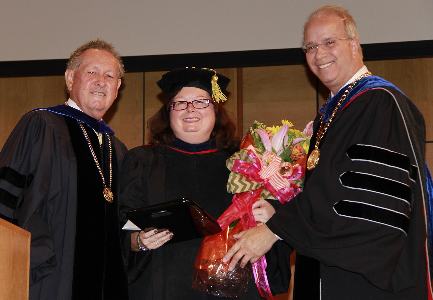 Dr. Twyla Hernandez, center, received the Non-Tentured Faculty Award from President Michael V. Carter, left, and Dr. Frank Cheatham, right, senior vice president for academic affairs. (Campbellsville University Photo by Rachel DeCoursey)